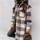 Oversized plaid shacket featuring a button front and chest pockets, designed for women, perfect for casual layering in a wool-style fabric. 1