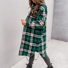 Oversized plaid shacket featuring a button front and chest pockets, designed for women, perfect for casual layering in a wool-style fabric. 2
