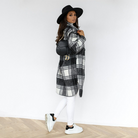 Oversized plaid shacket featuring a button front and chest pockets, designed for women, perfect for casual layering in a wool-style fabric. 4