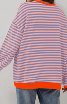 Oversized striped sweatshirt featuring neon contrast trim and drop shoulders, perfect for a stylish and comfortable casual look. 5