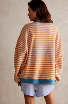 Oversized striped sweatshirt featuring neon contrast trim and drop shoulders, perfect for a stylish and comfortable casual look. 7