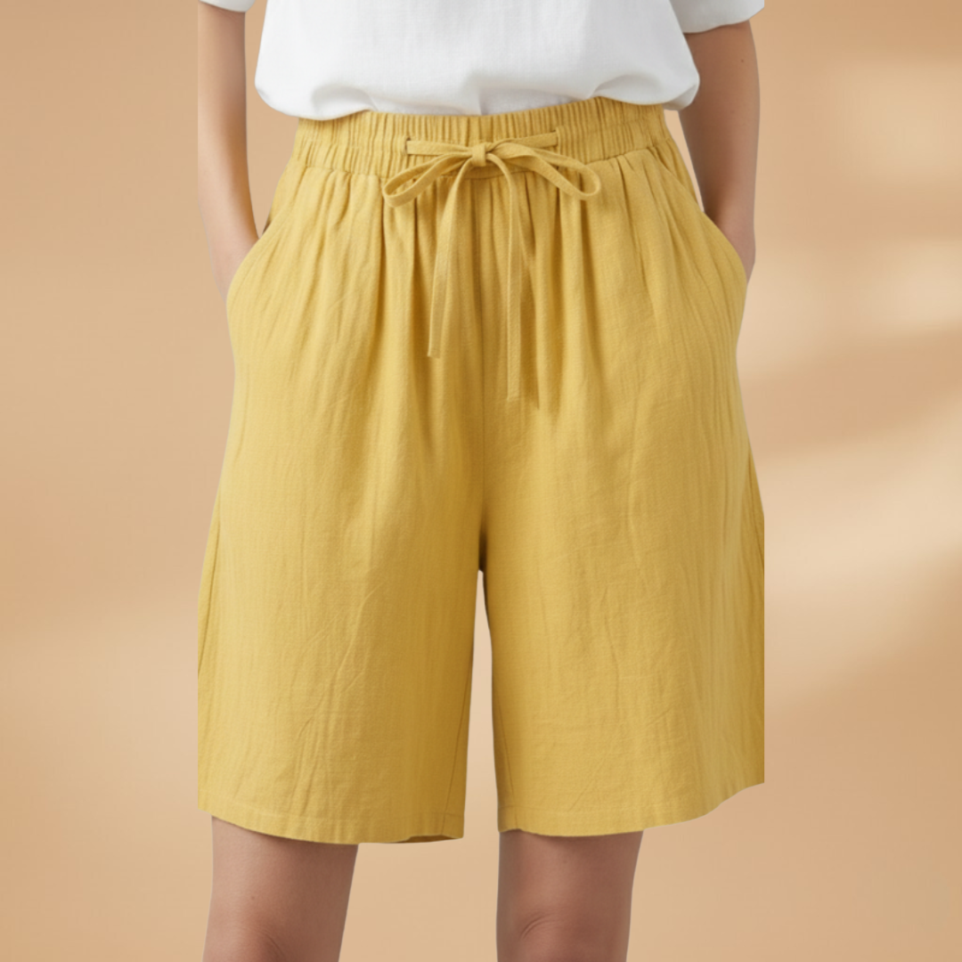 Lightweight relaxed linen shorts for women featuring an elastic waist and drawstring, perfect for summer wear. 0