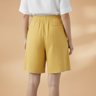 Lightweight relaxed linen shorts for women featuring an elastic waist and drawstring, perfect for summer wear. 1