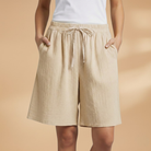 Lightweight relaxed linen shorts for women featuring an elastic waist and drawstring, perfect for summer wear. 11