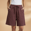 Lightweight relaxed linen shorts for women featuring an elastic waist and drawstring, perfect for summer wear. 13