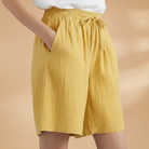 Lightweight relaxed linen shorts for women featuring an elastic waist and drawstring, perfect for summer wear. 2