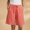 Lightweight relaxed linen shorts for women featuring an elastic waist and drawstring, perfect for summer wear. 4