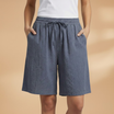 Lightweight relaxed linen shorts for women featuring an elastic waist and drawstring, perfect for summer wear. 6