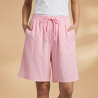 Lightweight relaxed linen shorts for women featuring an elastic waist and drawstring, perfect for summer wear. 8