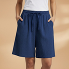 Lightweight relaxed linen shorts for women featuring an elastic waist and drawstring, perfect for summer wear. 9