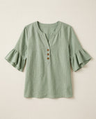 Ruffle blouse with V-neckline and decorative buttons, showcasing a feminine elegant design in soft fabric, perfect for stylish casual or formal wear. 0