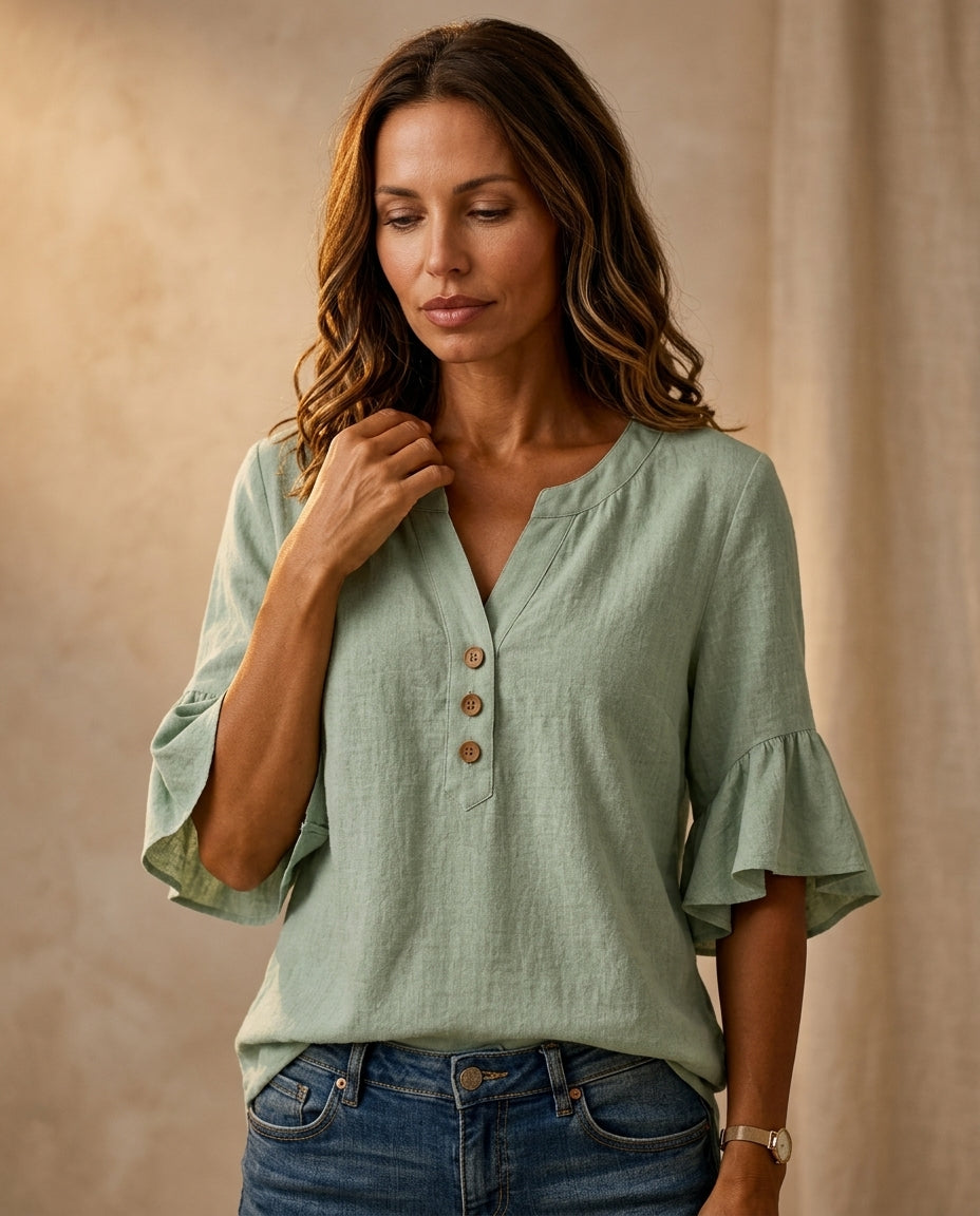 Ruffle blouse with V-neckline and decorative buttons, showcasing a feminine elegant design in soft fabric, perfect for stylish casual or formal wear. 1