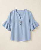Ruffle blouse with V-neckline and decorative buttons, showcasing a feminine elegant design in soft fabric, perfect for stylish casual or formal wear. 2