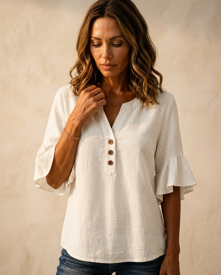 Ruffle blouse with V-neckline and decorative buttons, showcasing a feminine elegant design in soft fabric, perfect for stylish casual or formal wear. 7