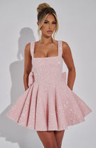 Sequin mini dress with flared skirt and back bow detail, perfect for wedding guests and cocktail parties. 0