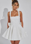 Sequin mini dress with flared skirt and back bow detail, perfect for wedding guests and cocktail parties. 2