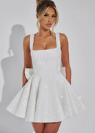 Sequin mini dress with flared skirt and back bow detail, perfect for wedding guests and cocktail parties. 2