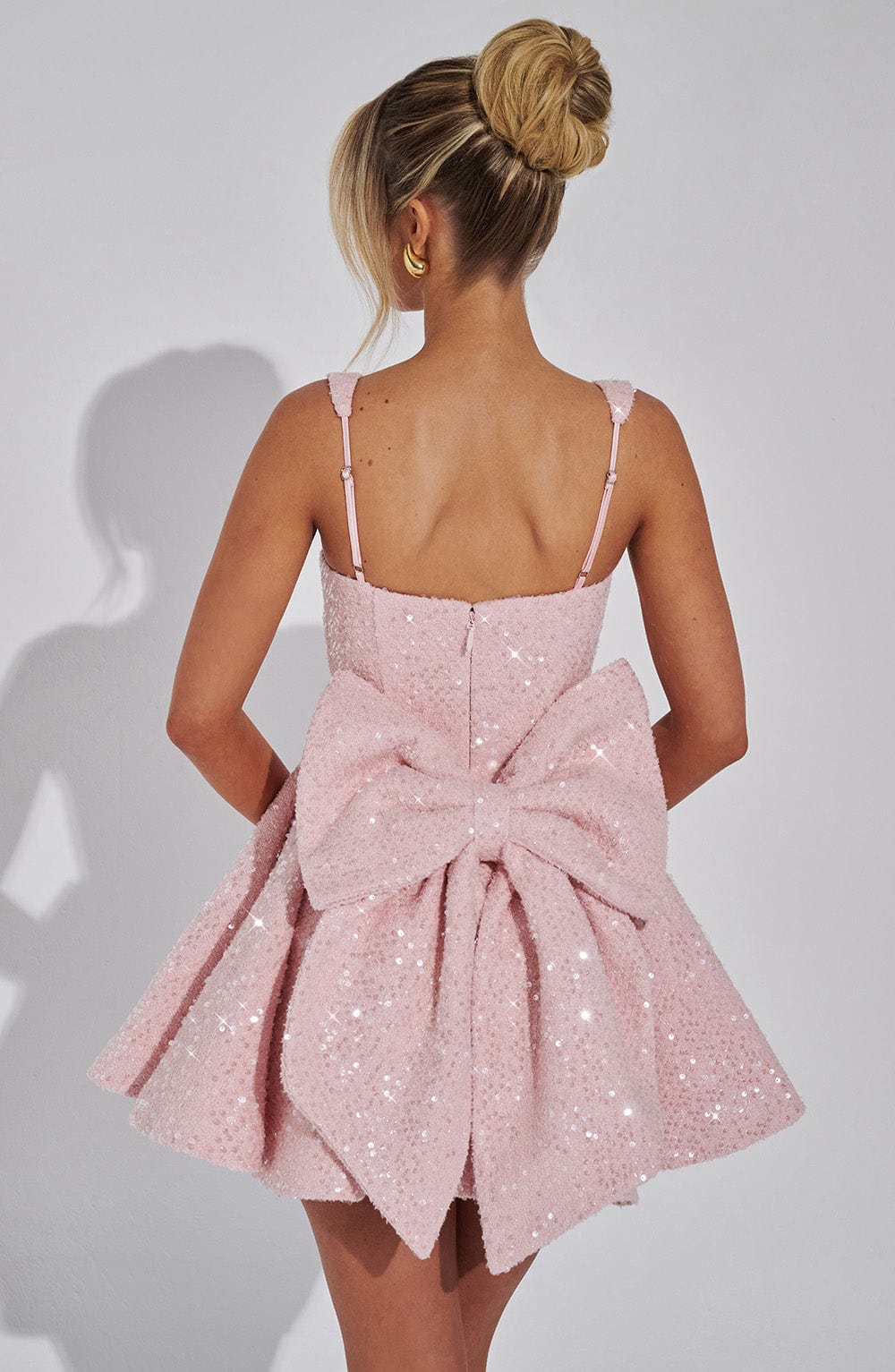 Sequin mini dress with flared skirt and back bow detail, perfect for wedding guests and cocktail parties. 3