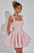 Sequin mini dress with flared skirt and back bow detail, perfect for wedding guests and cocktail parties. 4