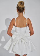 Sequin mini dress with flared skirt and back bow detail, perfect for wedding guests and cocktail parties. 8