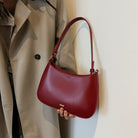 Shoulder bag with adjustable strap, featuring a minimalist curved design in vegan leather, perfect for everyday use and compact storage. 4