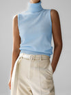 Sleeveless knit top for women featuring a soft turtleneck design and ribbed hem, perfect for layering or wearing alone. 2