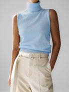 Sleeveless knit top for women featuring a soft turtleneck design and ribbed hem, perfect for layering or wearing alone. 2