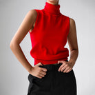 Sleeveless knit top for women featuring a soft turtleneck design and ribbed hem, perfect for layering or wearing alone. 4