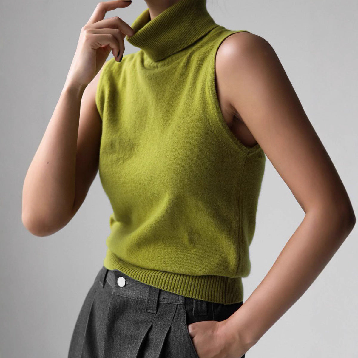 Sleeveless knit top for women featuring a soft turtleneck design and ribbed hem, perfect for layering or wearing alone. 6