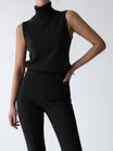 Sleeveless knit top for women featuring a soft turtleneck design and ribbed hem, perfect for layering or wearing alone. 7