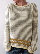Striped knit sweater featuring a relaxed fit and a two-tone design with a patterned hem, perfect for casual wear and hip-length styling. 2