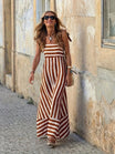 Elegant striped maxi dress featuring adjustable tie straps and a flowing full skirt, perfect for women seeking stylish and comfortable summer wear. 0
