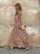 Elegant striped maxi dress featuring adjustable tie straps and a flowing full skirt, perfect for women seeking stylish and comfortable summer wear. 1