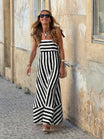 Elegant striped maxi dress featuring adjustable tie straps and a flowing full skirt, perfect for women seeking stylish and comfortable summer wear. 2