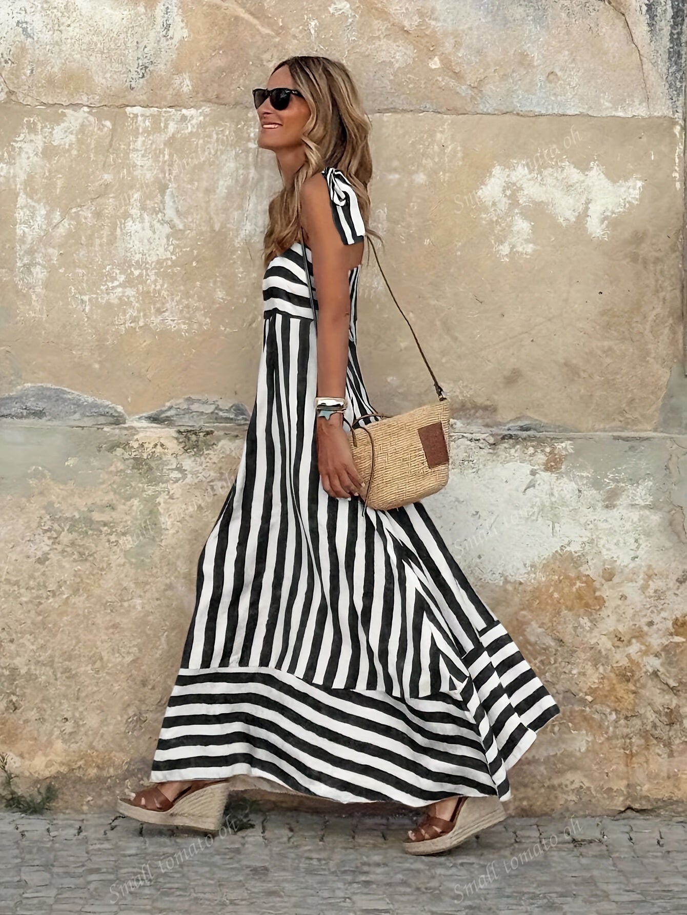 Elegant striped maxi dress featuring adjustable tie straps and a flowing full skirt, perfect for women seeking stylish and comfortable summer wear. 3