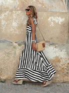 Elegant striped maxi dress featuring adjustable tie straps and a flowing full skirt, perfect for women seeking stylish and comfortable summer wear. 3