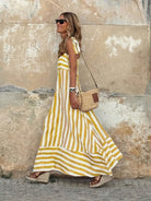 Elegant striped maxi dress featuring adjustable tie straps and a flowing full skirt, perfect for women seeking stylish and comfortable summer wear. 4