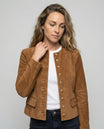 Tan suede jacket featuring a gold button front and a stylish collarless neckline, designed in a cropped tailored fit for a chic, modern look. 0