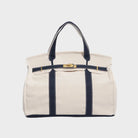 Vintage linen canvas tote bag featuring reinforced handles and a secure snap closure, designed for water resistance and ample space, perfect for everyday use. 0