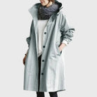 Waterproof trench coat for women featuring an adjustable belt, designed as a long raincoat in a timeless style for ultimate protection against the elements. 2