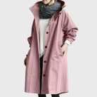 Waterproof trench coat for women featuring an adjustable belt, designed as a long raincoat in a timeless style for ultimate protection against the elements. 5