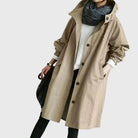 Waterproof trench coat for women featuring a hood and adjustable belt, ideal for stylish protection against rain. 3