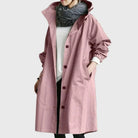 Waterproof trench coat for women featuring a hood and adjustable belt, ideal for stylish protection against rain. 5