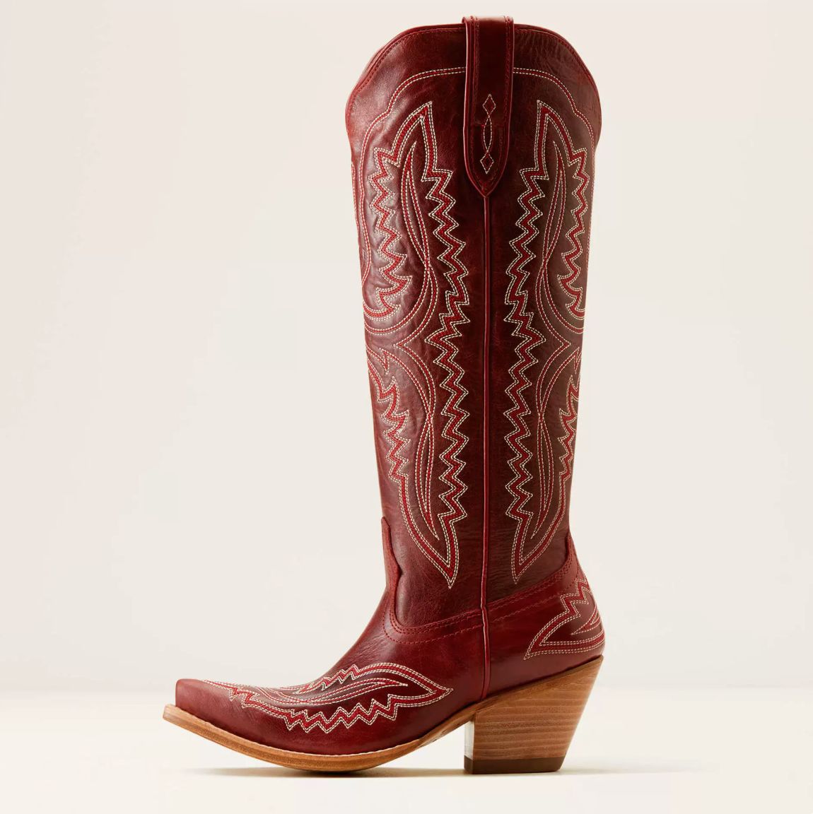 Western boot featuring a sculpted heart design, crafted in ruby leather finish with stylish metal stud accents. 0
