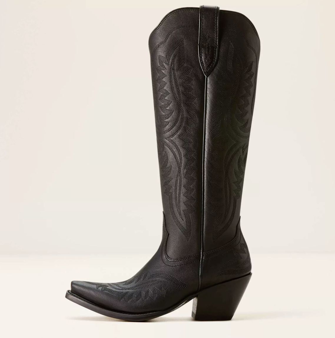 Western boot featuring a sculpted heart design and metal stud embellishments, crafted in a sleek raven leather finish. 0