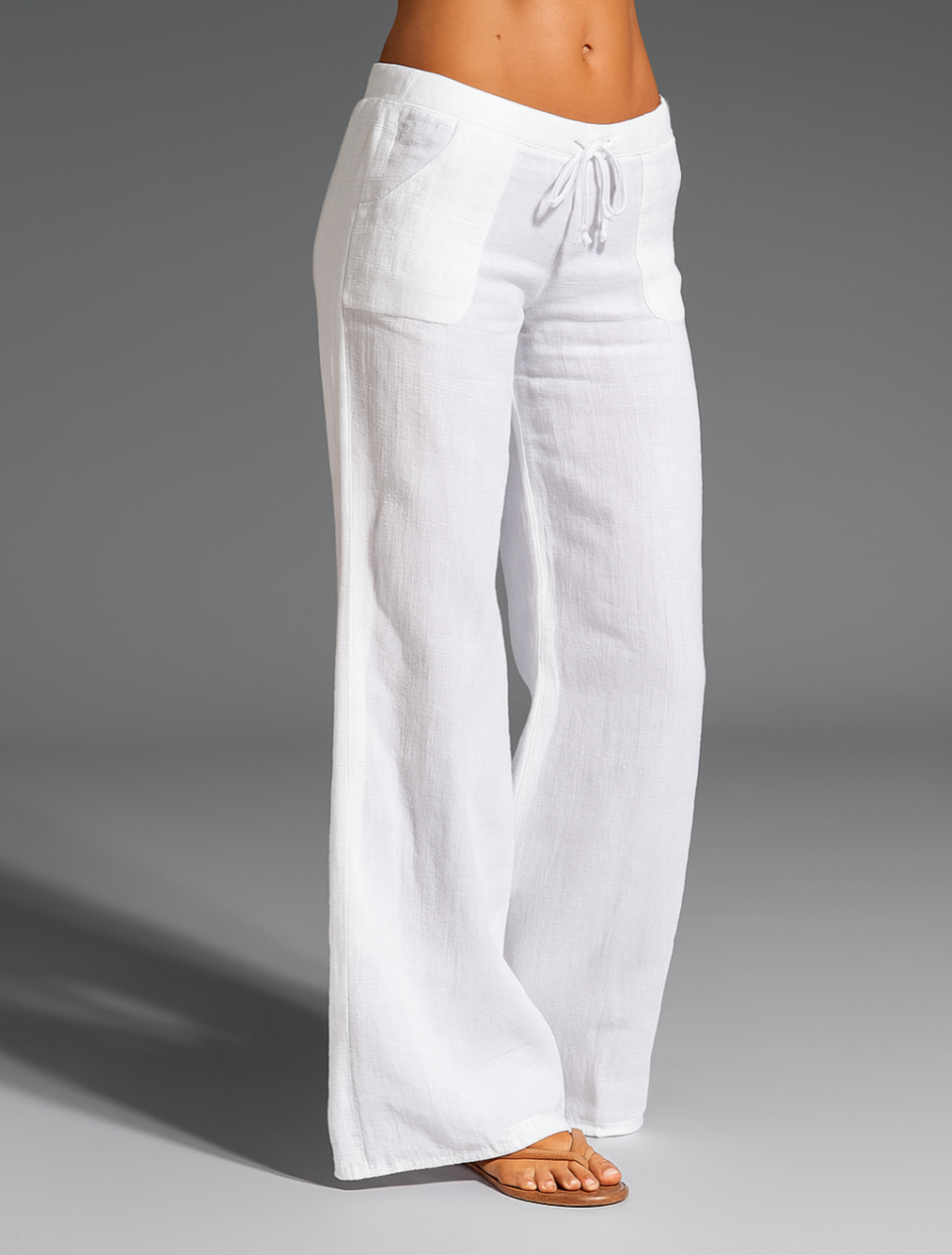 Wide leg linen trousers with drawstring waist, featuring a relaxed fit for women, perfect for casual outings in natural linen fabric. 0