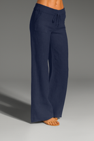 Wide leg linen trousers with drawstring waist, featuring a relaxed fit for women, perfect for casual outings in natural linen fabric. 1