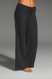 Wide leg linen trousers with drawstring waist, featuring a relaxed fit for women, perfect for casual outings in natural linen fabric. 2