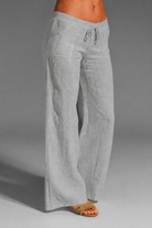 Wide leg linen trousers with drawstring waist, featuring a relaxed fit for women, perfect for casual outings in natural linen fabric. 3