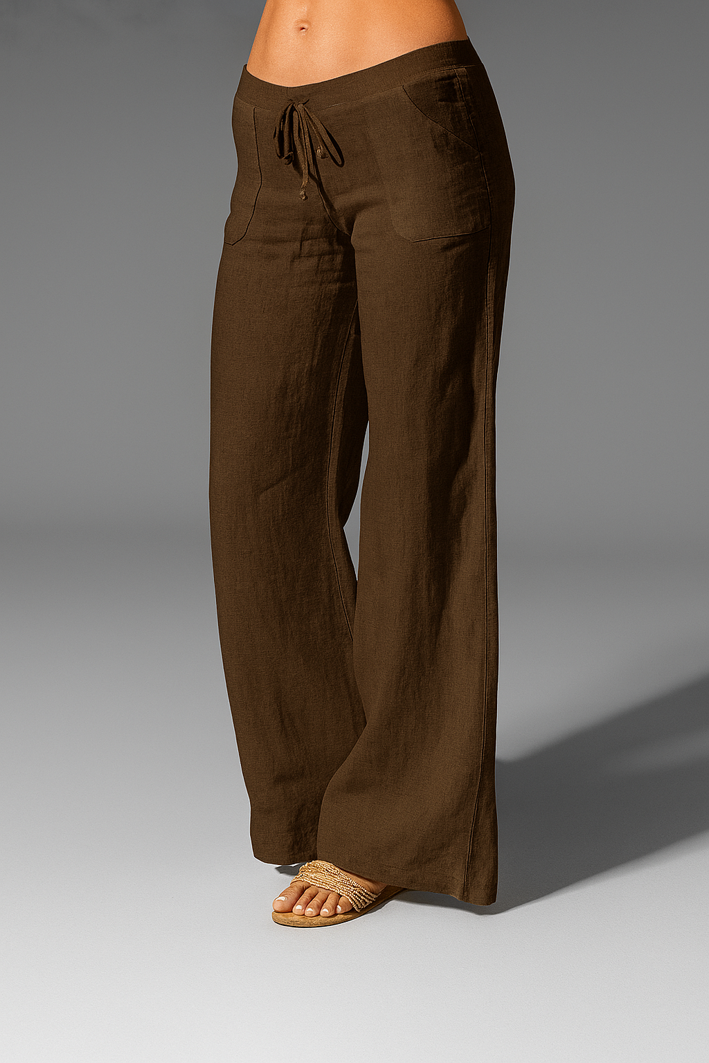 Wide leg linen trousers with drawstring waist, featuring a relaxed fit for women, perfect for casual outings in natural linen fabric. 4